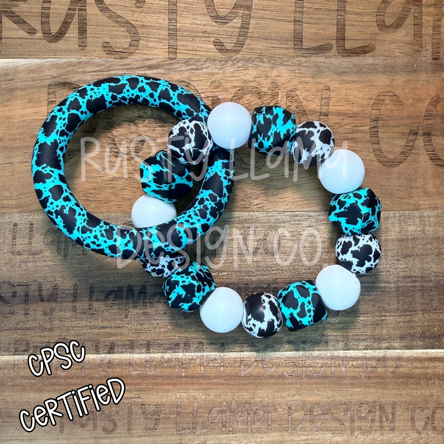 CPSC-Certified Silicone Baby Rattle β Turquoise Cow Print