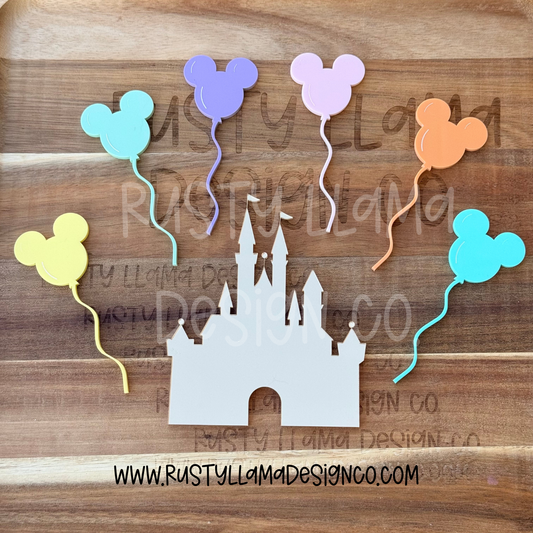 Decorative cutout of a castle with Mickey Mouse balloons